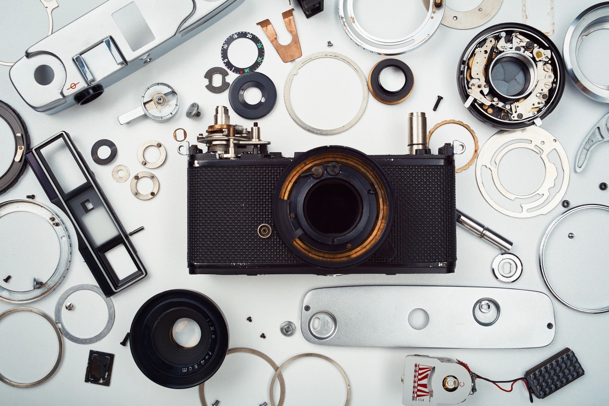 Disassembled vintage film camera parts flat lay