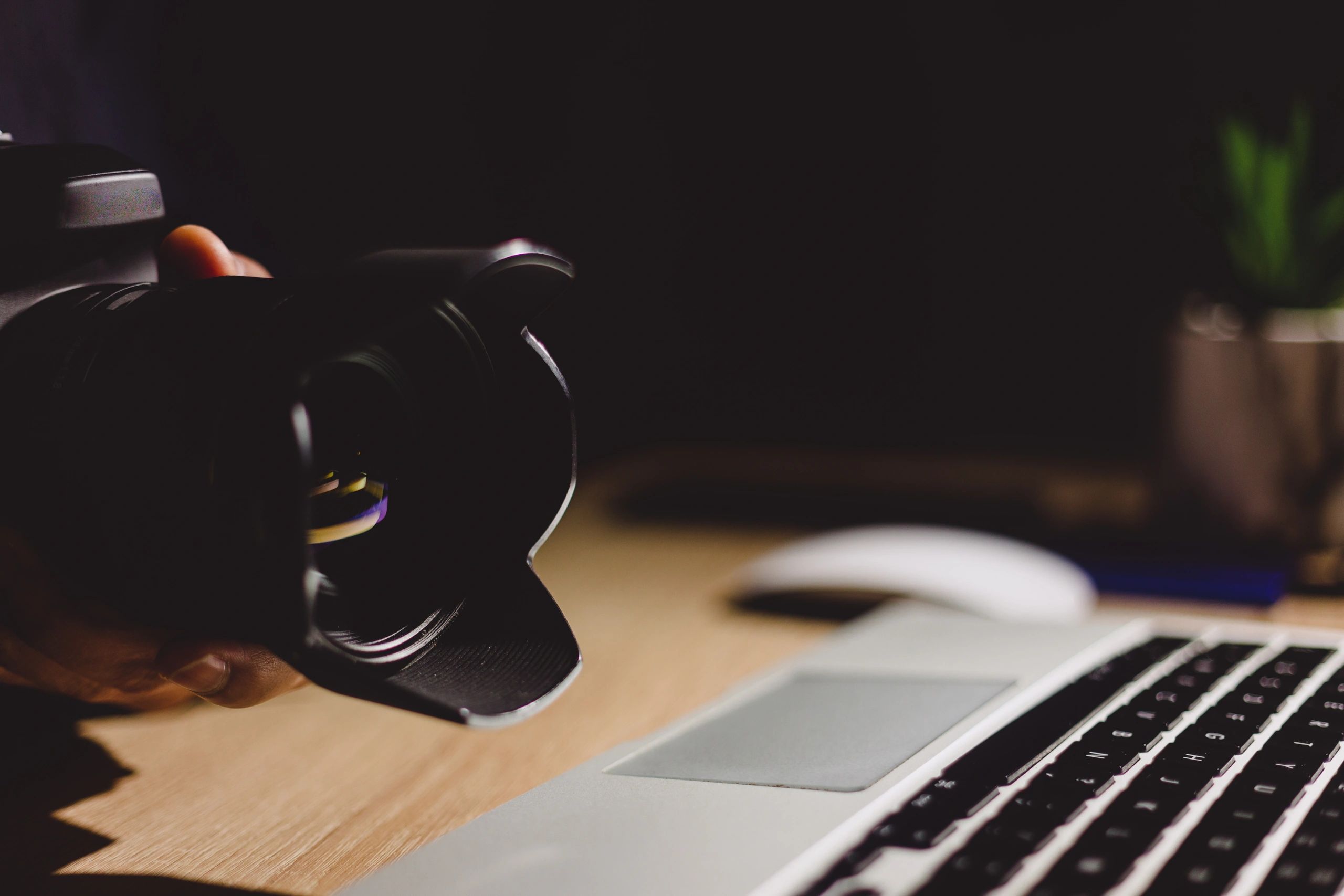 Photographer workspace with camera gear and laptop