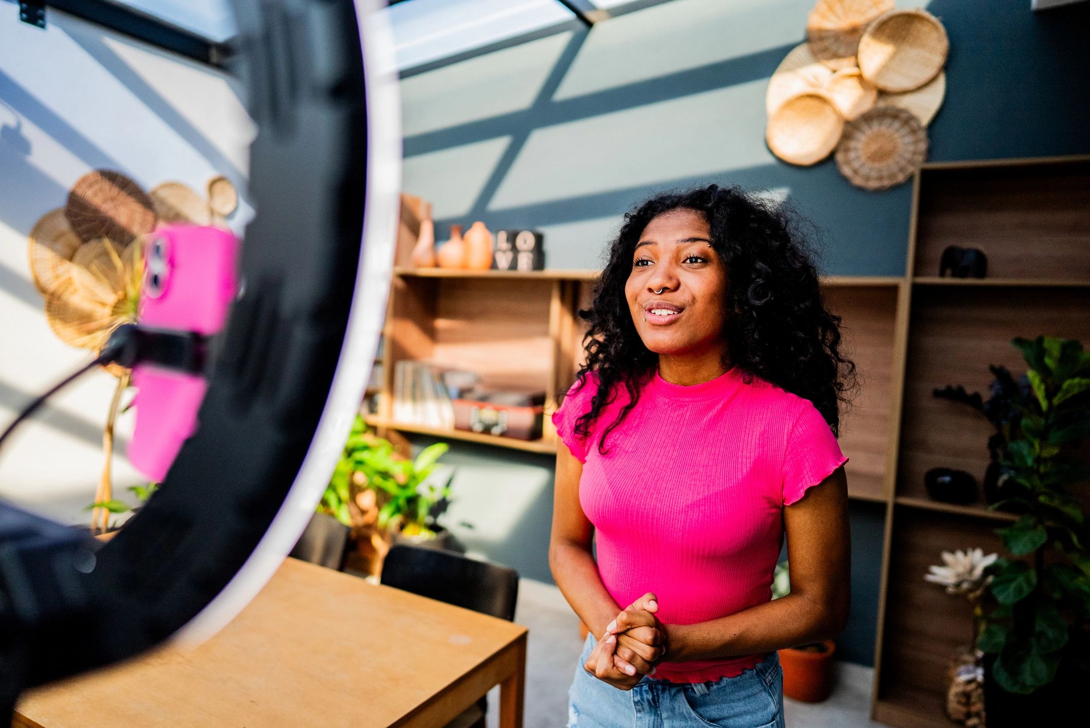 Content creator filming with ring light in a home studio